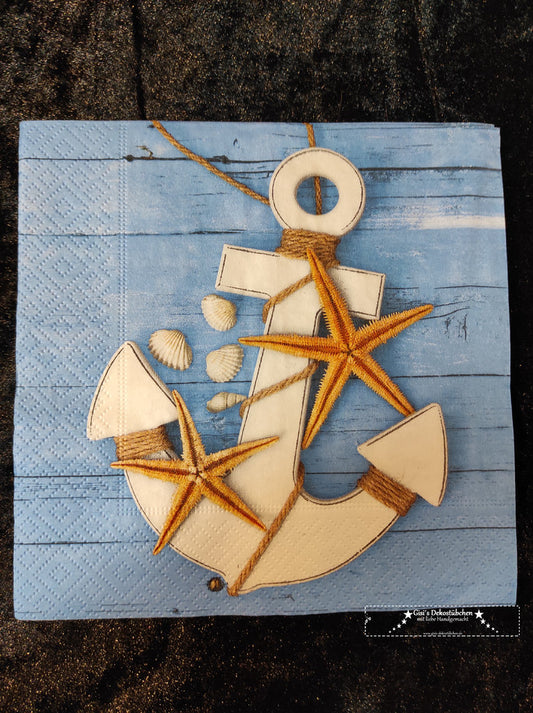 Anchors, starfish &amp; shells in front of a wooden wall