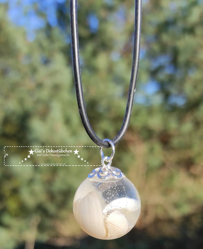 Resin pendant in the shape of a sphere, with shells
