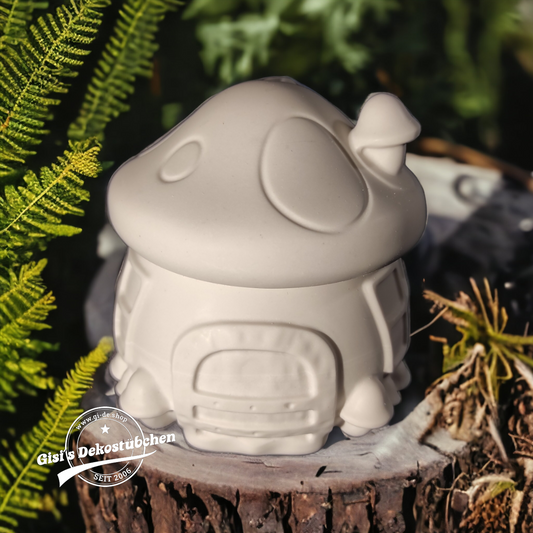 Cute ceramic mushroom in the shape of a box with a door and chimney.