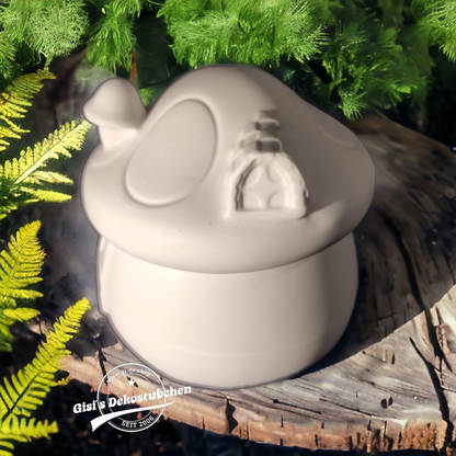 Cute ceramic mushroom in the shape of a box with a door and chimney.