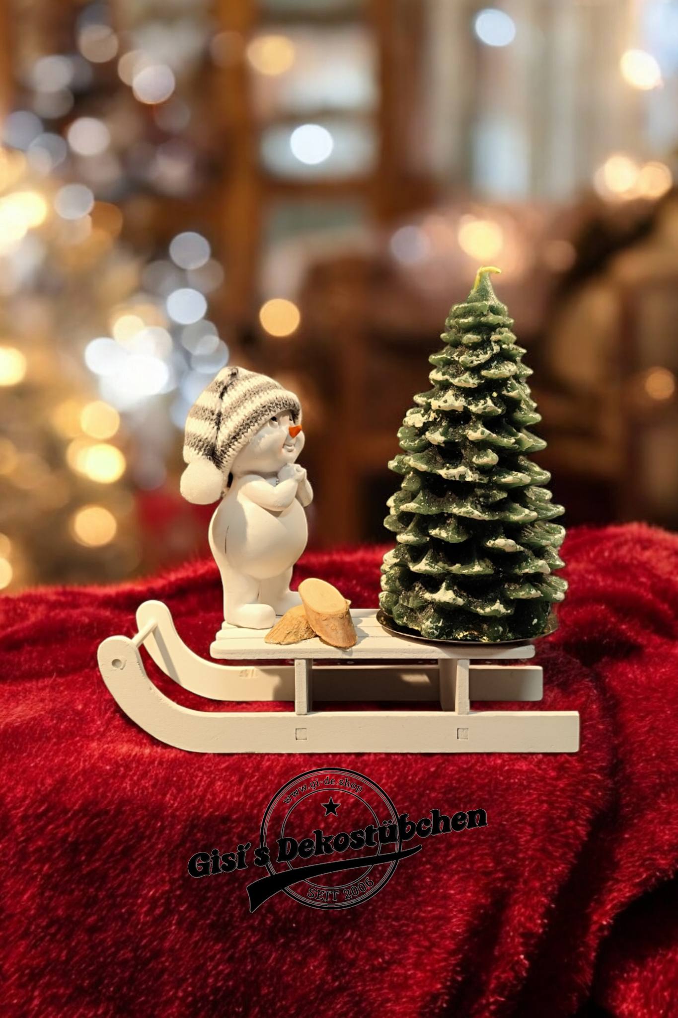 Christmas decorations with sled, snowman, Christmas tree candle and green wooden slices