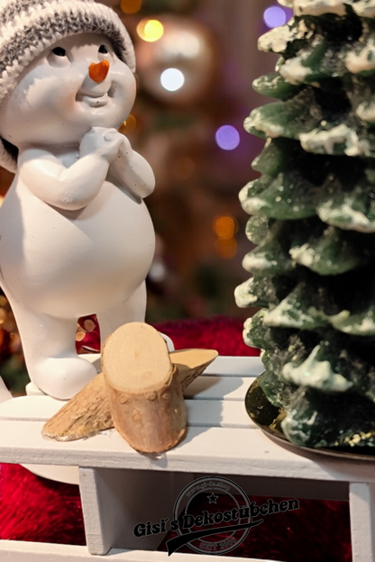 Christmas decorations with sled, snowman, Christmas tree candle and green wooden slices